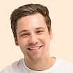 Friendly headshot portrait of a smiling short-haired man
