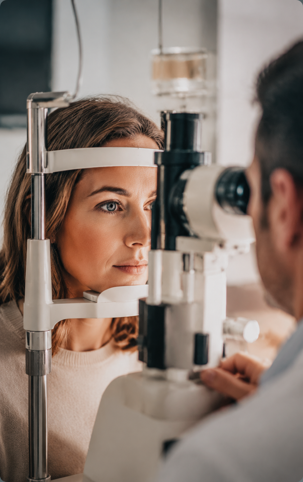 A patient undergoing a professional eye examination with equipment